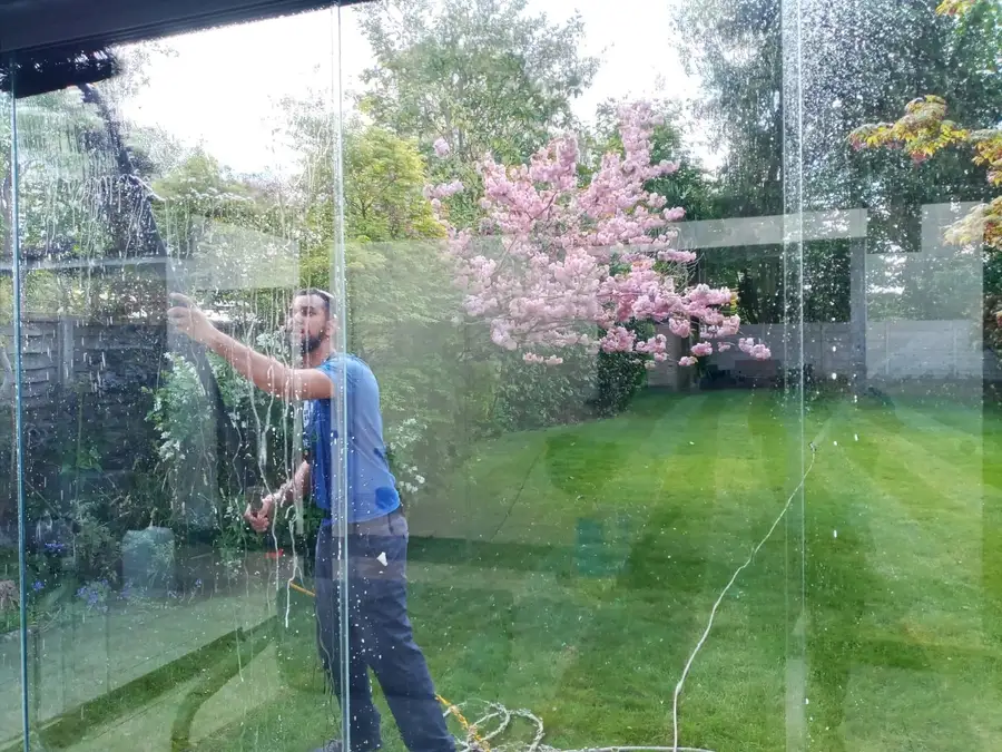 Cleaning glass sliding doors on a garden extension