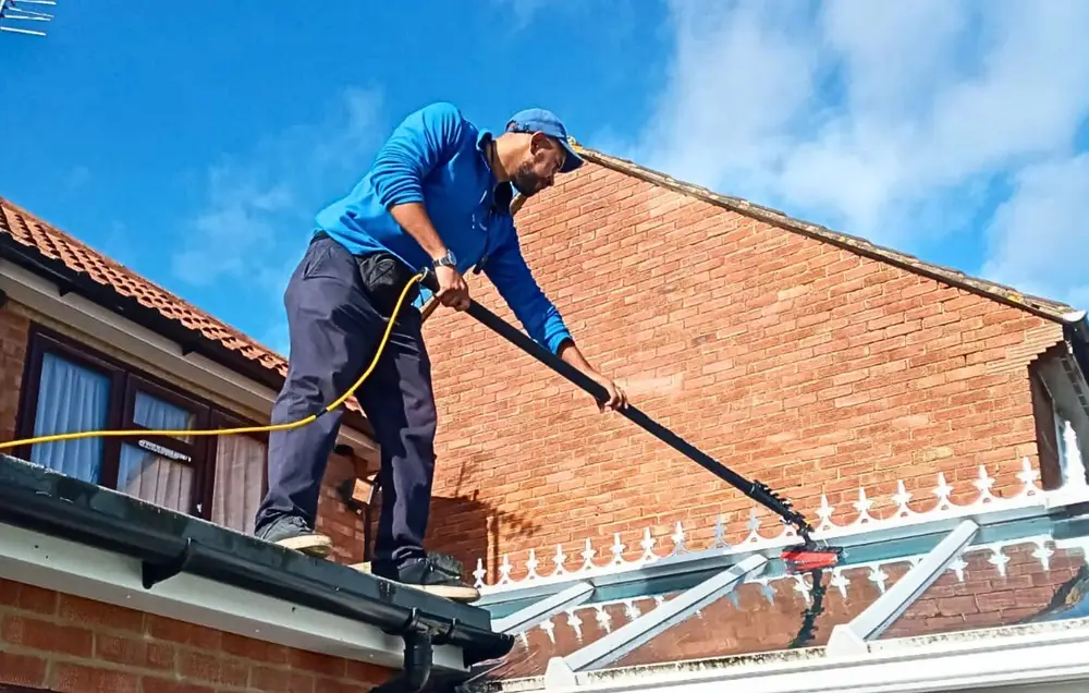 Cleaning a conservatory roof in Greenford with a water-fed brush